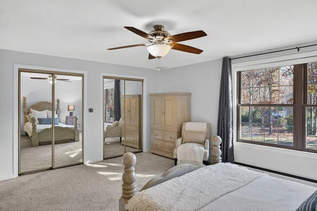 a living room with furniture and two window