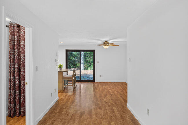 195 Falmouth Road, Unit 10E Mashpee, MA 02649 - Photo 3 of 33 a view of an empty room with wooden floor and a window
