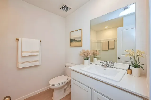 a bathroom with a sink toilet and a mirror