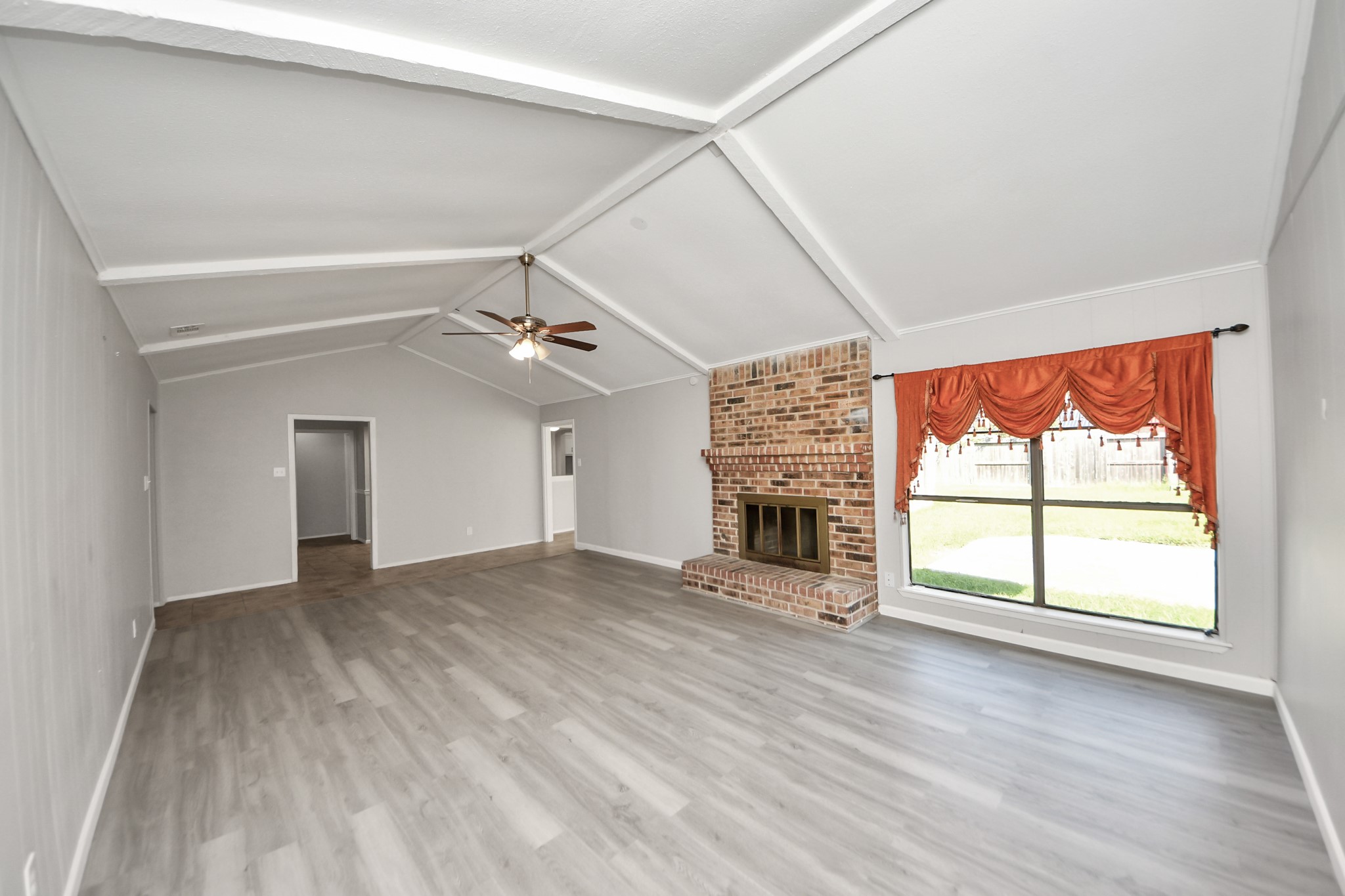 7303 Foxwick Lane Humble, TX 77338 - Photo 11 of 38 an empty room with windows and fireplace