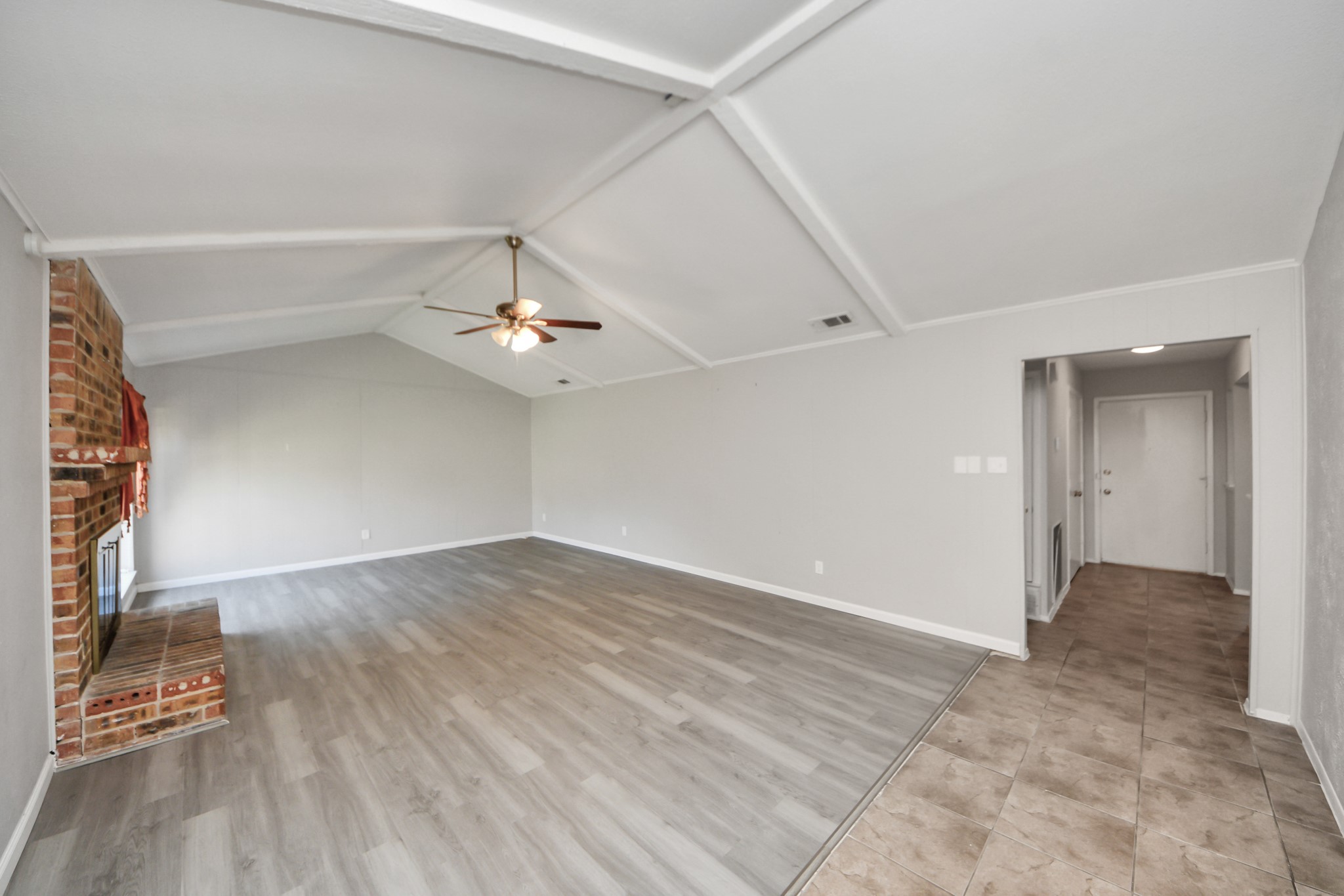 7303 Foxwick Lane Humble, TX 77338 - Photo 12 of 38 wooden floor in an empty room with a window