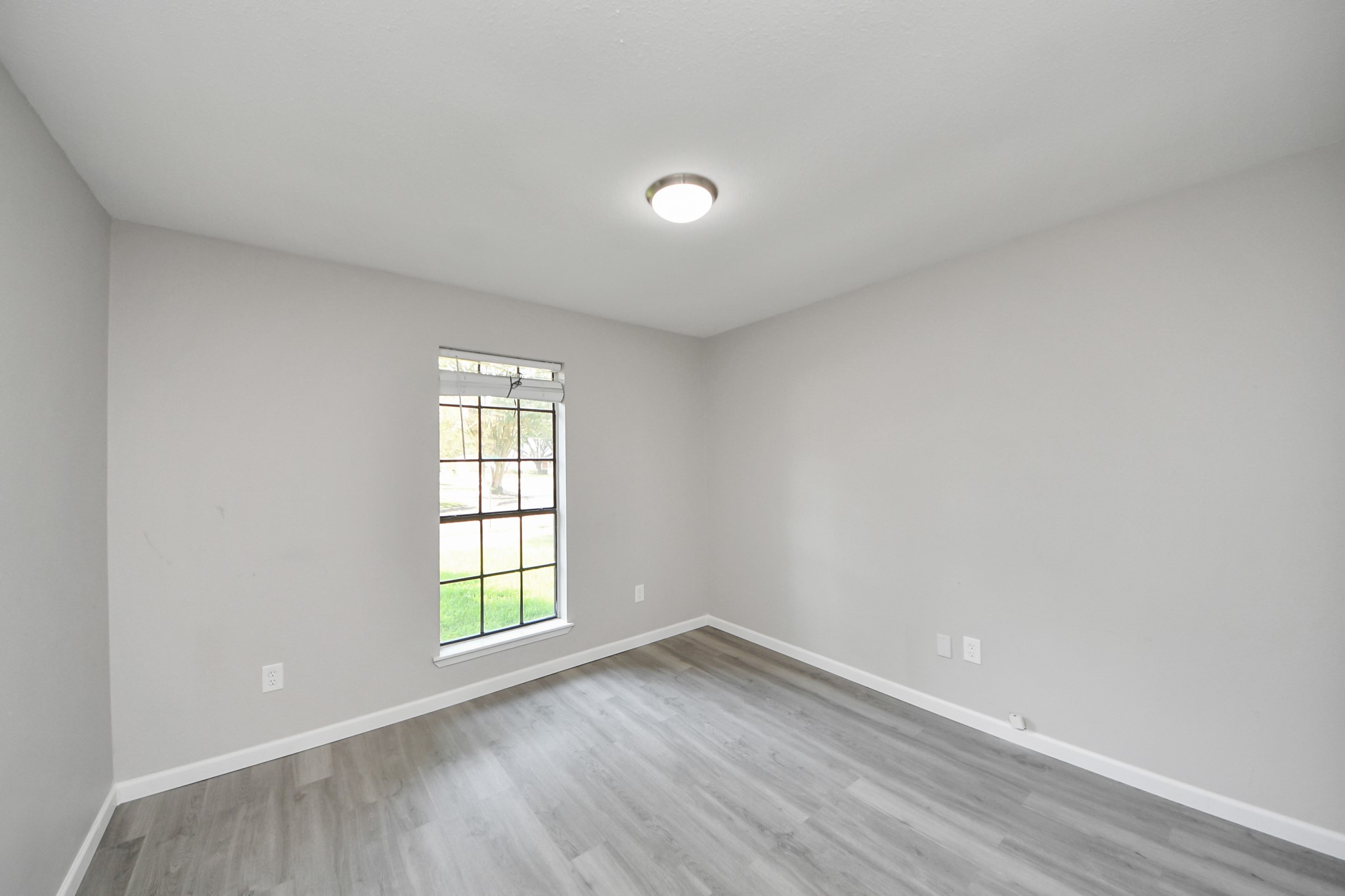 7303 Foxwick Lane Humble, TX 77338 - Photo 17 of 38 wooden floor in an empty room with a window