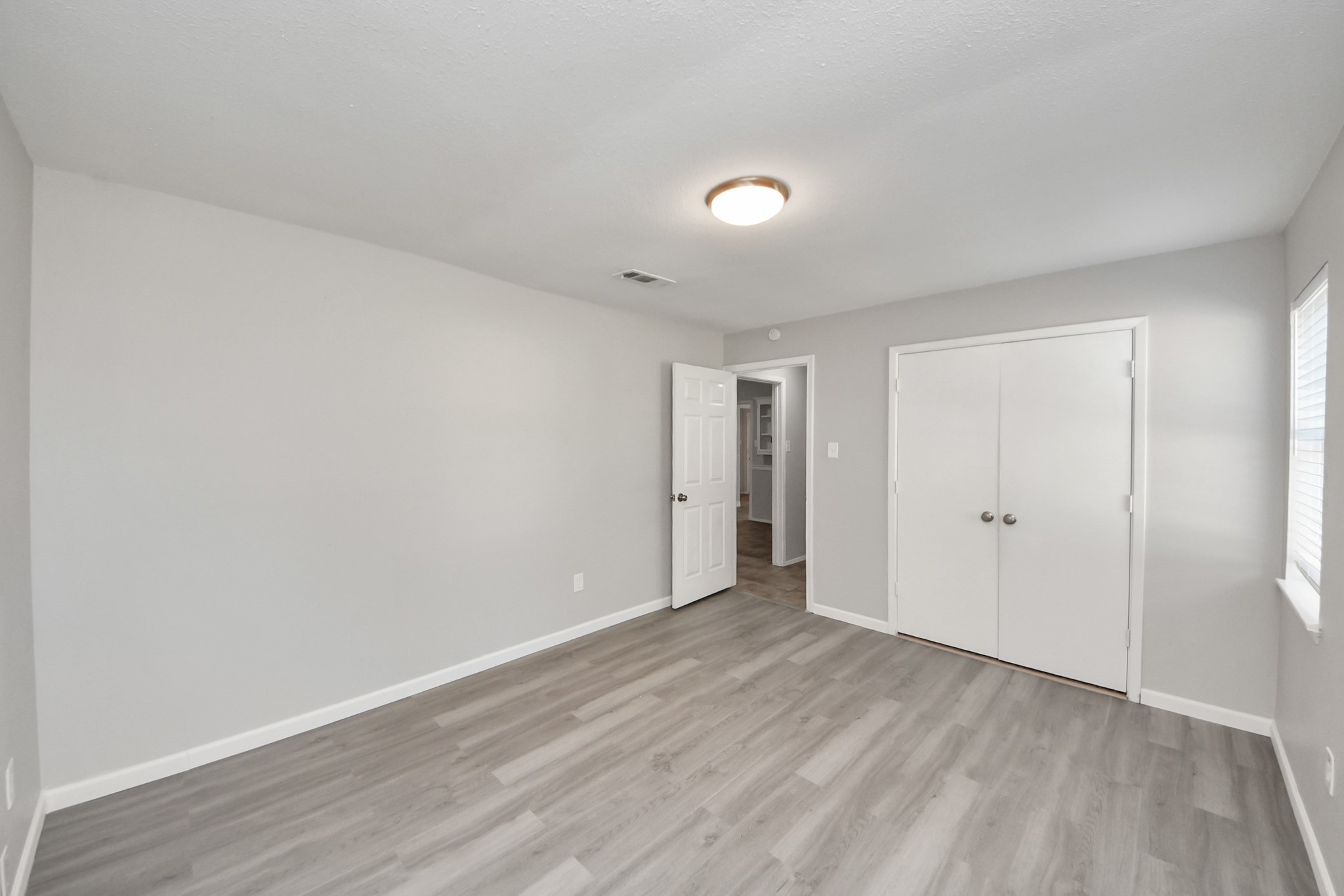 7303 Foxwick Lane Humble, TX 77338 - Photo 20 of 38 a view of an empty room with wooden floor