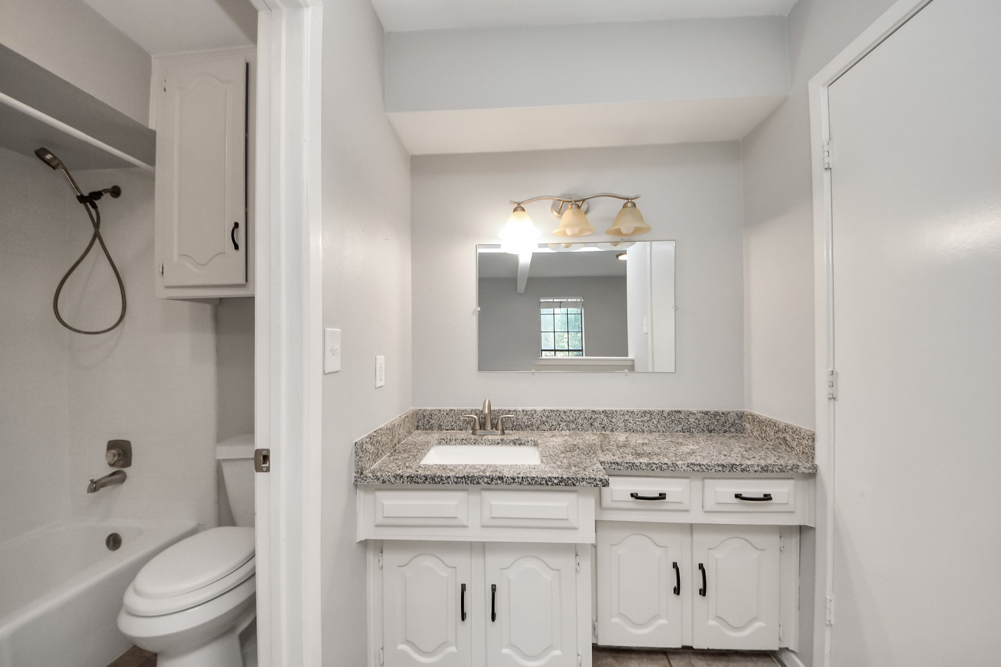 7303 Foxwick Lane Humble, TX 77338 - Photo 23 of 38 a bathroom with a granite countertop sink a toilet and a mirror