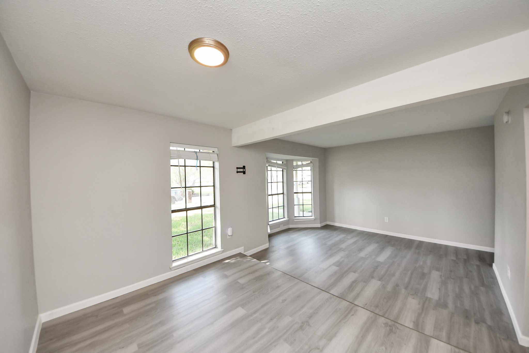 7303 Foxwick Lane Humble, TX 77338 - Photo 24 of 38 a view of an empty room with wooden floor and a window