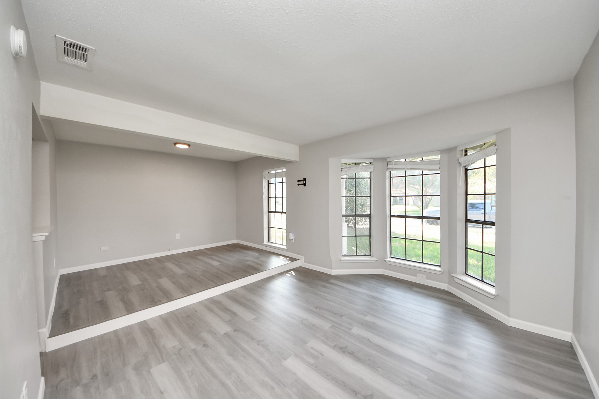 7303 Foxwick Lane Humble, TX 77338 - Photo 25 of 38 an empty room with wooden floor and windows
