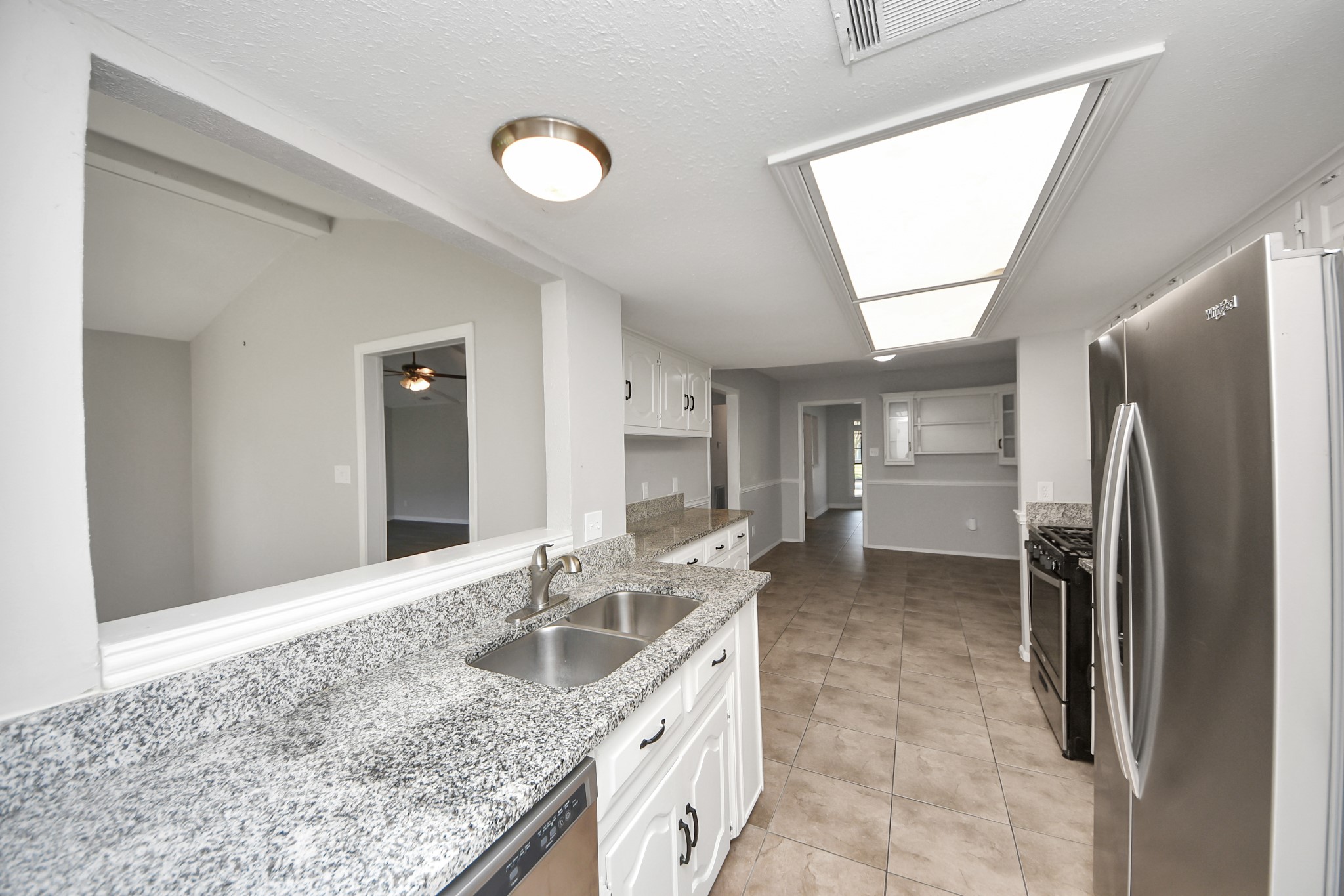 7303 Foxwick Lane Humble, TX 77338 - Photo 29 of 38 a kitchen with stainless steel appliances granite countertop a sink refrigerator and cabinets