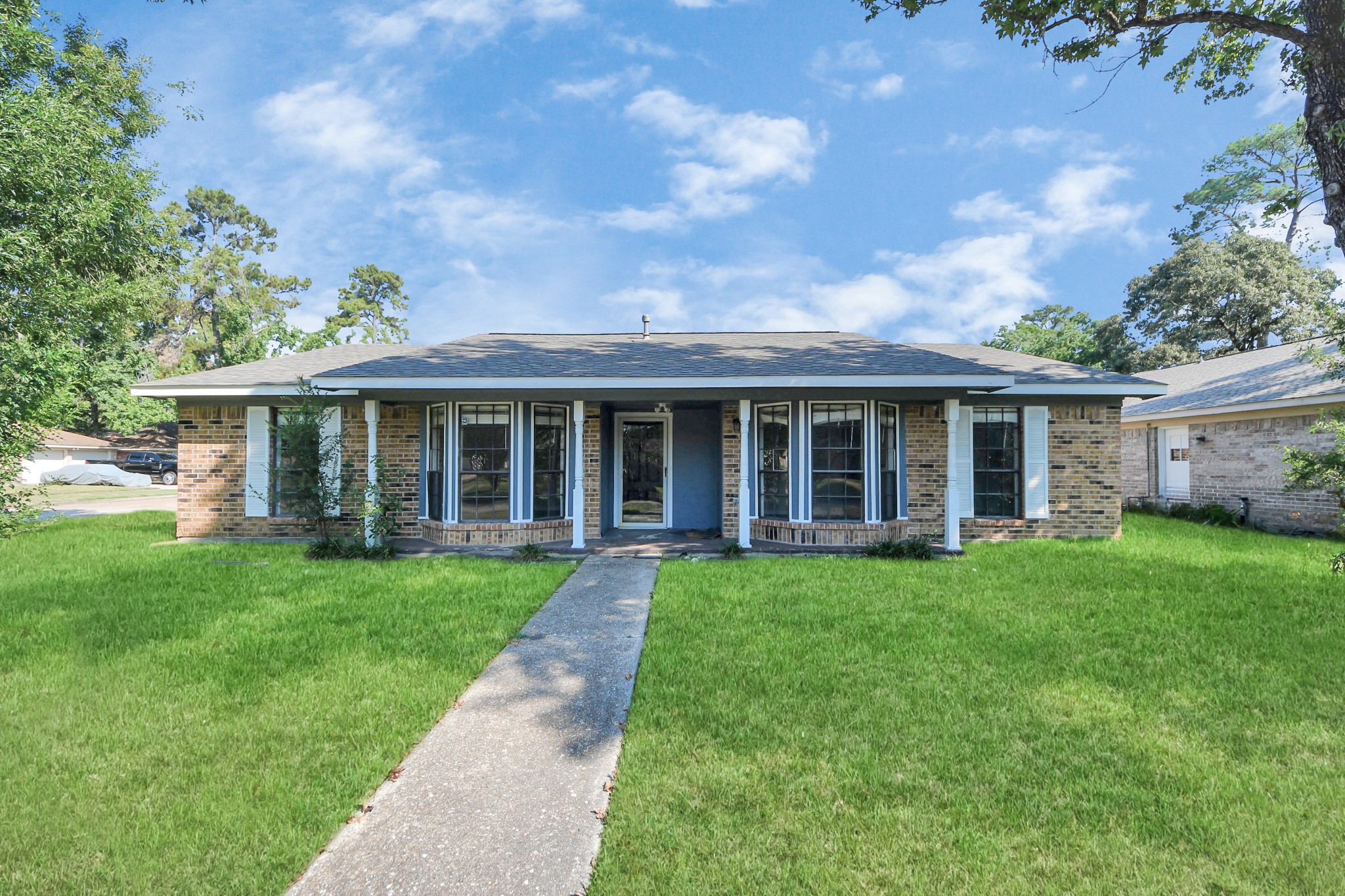 7303 Foxwick Lane Humble, TX 77338 - Photo 3 of 38 front view of a house with a yard