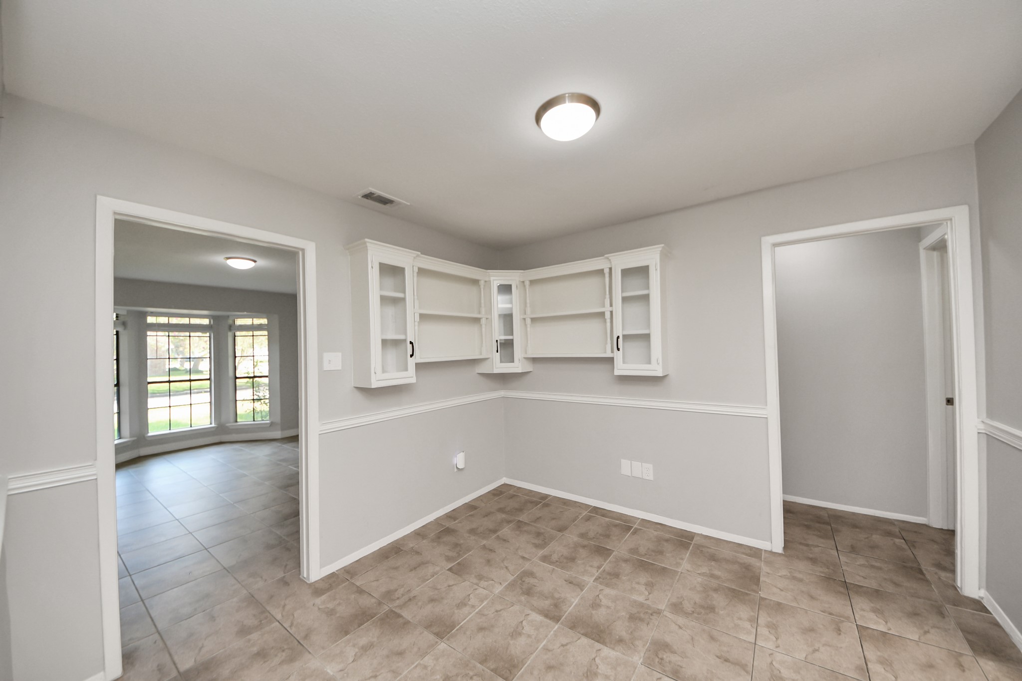 7303 Foxwick Lane Humble, TX 77338 - Photo 34 of 38 a view of a big room with wooden cabinet and windows