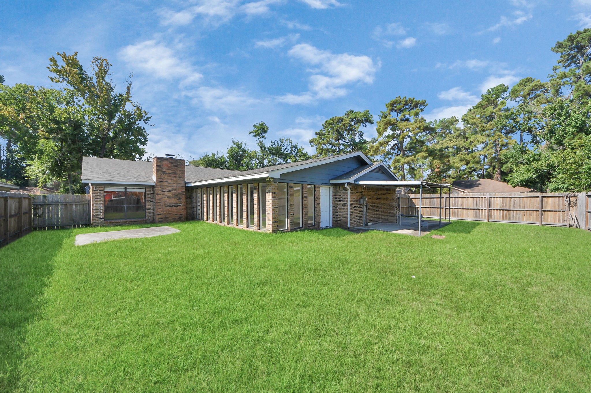 7303 Foxwick Lane Humble, TX 77338 - Photo 37 of 38 a view of a backyard with table and chairs and a large tree
