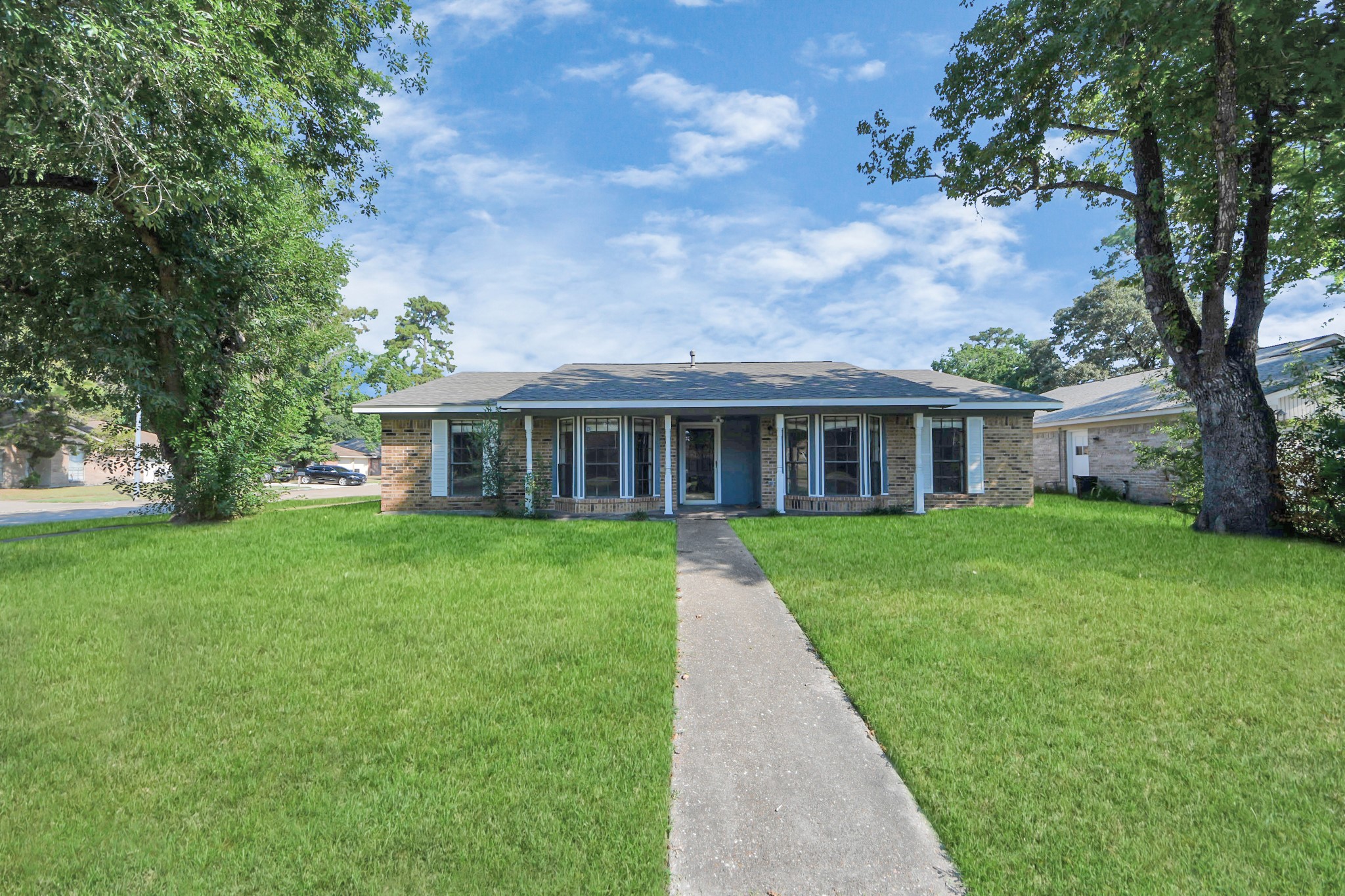 7303 Foxwick Lane Humble, TX 77338 - Photo 4 of 38 a view of house in front of a big yard with large trees