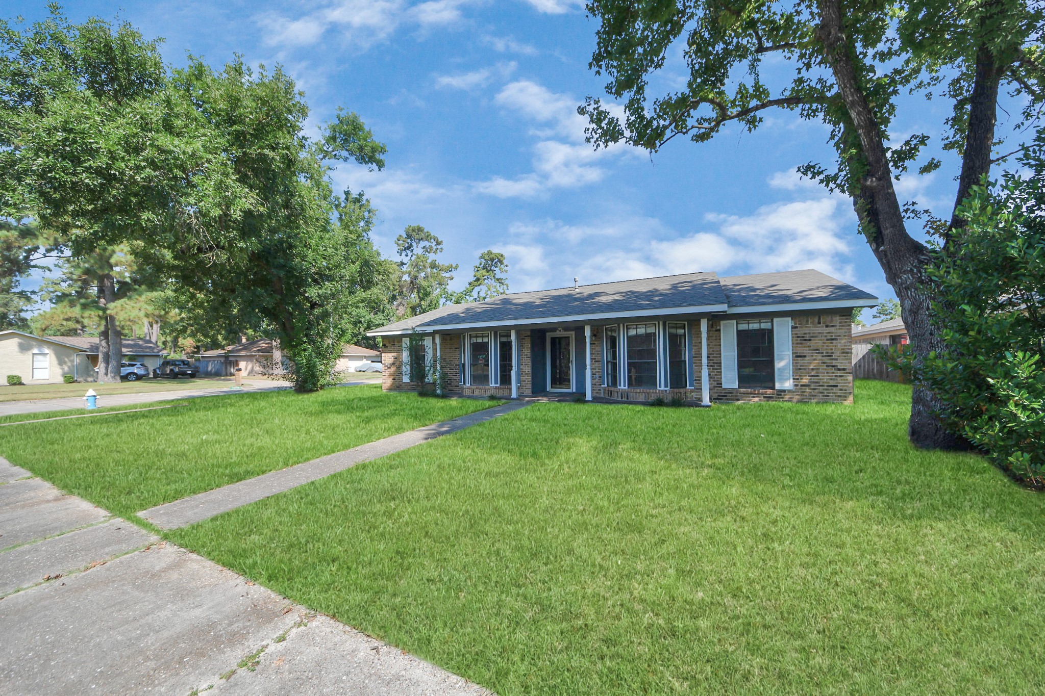 7303 Foxwick Lane Humble, TX 77338 - Photo 5 of 38 a view of house in front of a big yard with large trees