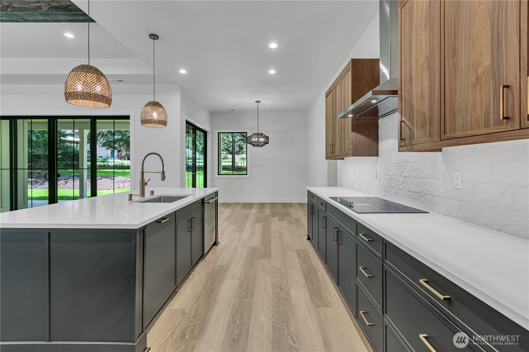 6709 254th Street East Graham, WA 98338 - Photo 14 of 40 a large kitchen with stainless steel appliances a large counter top a stove and a sink