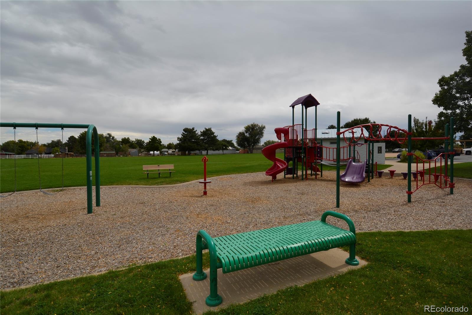 4975 Howell Street Golden, CO 80403 - Photo 18 of 23 an outdoor space with lots of swings and slides