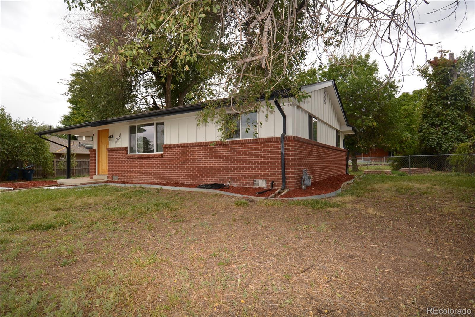 4975 Howell Street Golden, CO 80403 - Photo 4 of 23 a view of a house with a yard