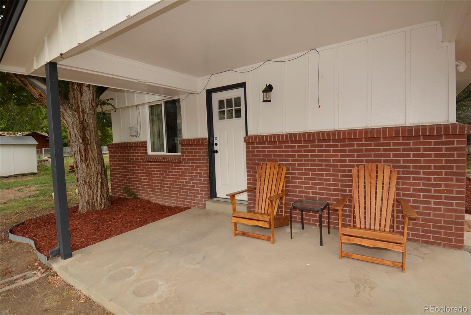 4975 Howell Street Golden, CO 80403 - Photo 6 of 23 a view of a patio with table and chairs with wooden fence