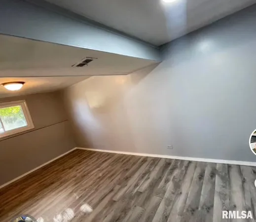 a view of a room with wooden floor