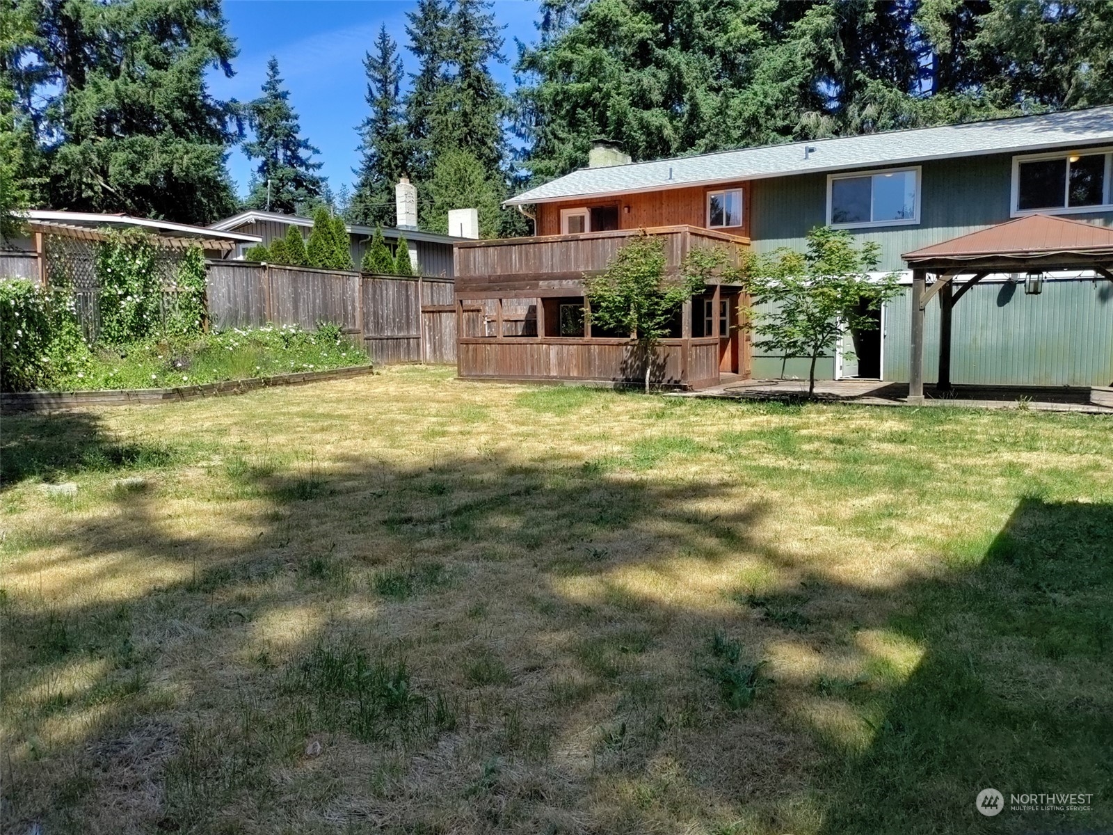 16032 Spanaway Loop Road South Spanaway, WA 98387 - Photo 17 of 28 a front view of house with yard and trees in the background