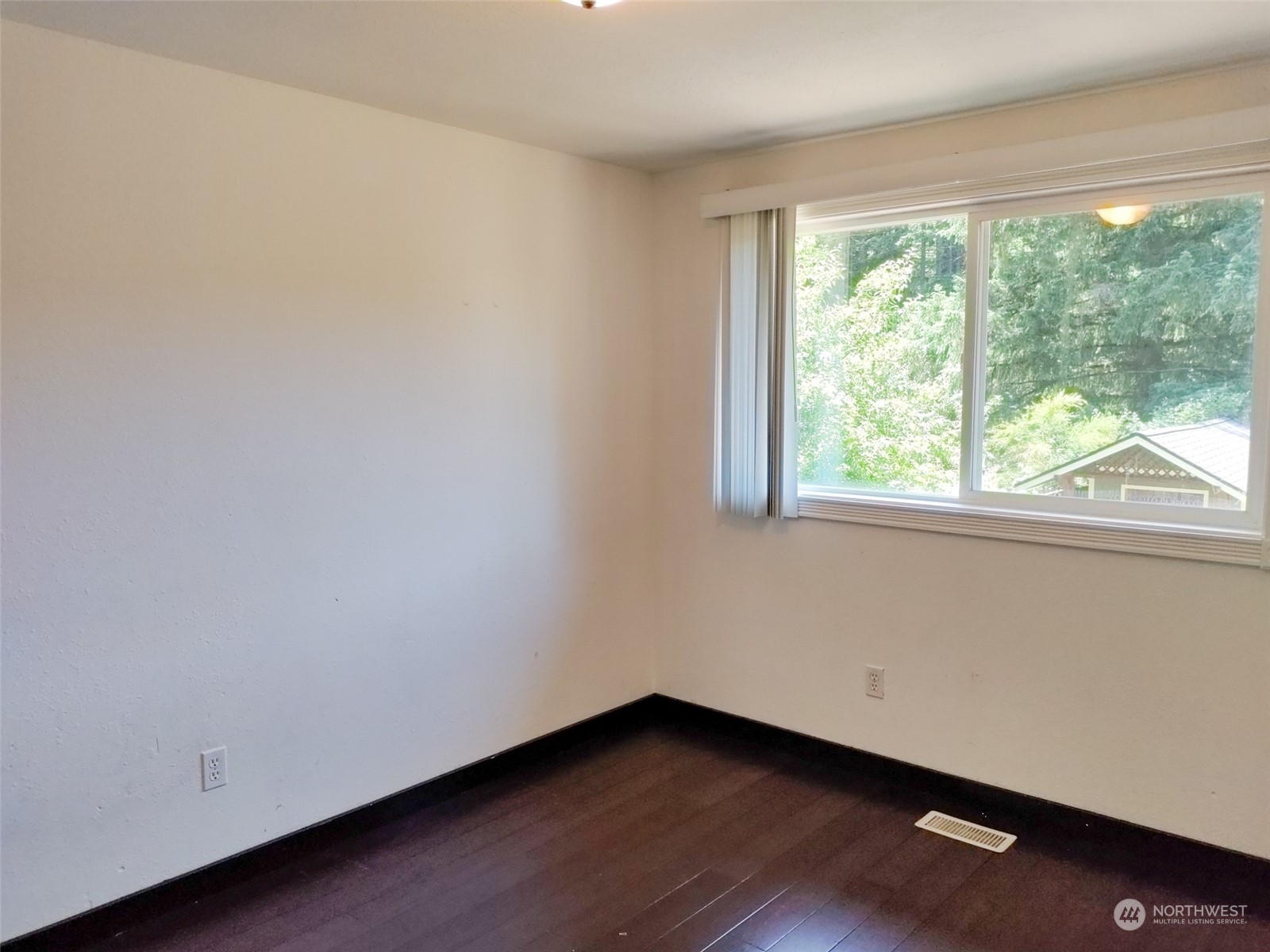 16032 Spanaway Loop Road South Spanaway, WA 98387 - Photo 8 of 28 a view of an empty room with wooden floor and a window