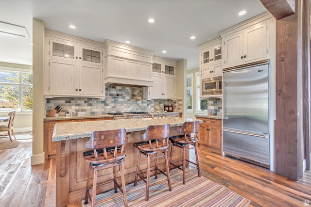 2579 Splendor Valley Road Kamas, UT 84036 - Photo 85 of 87 Kitchen with glass insert cabinets, built in appliances, light stone countertops, light wood-type flooring, and recessed lighting