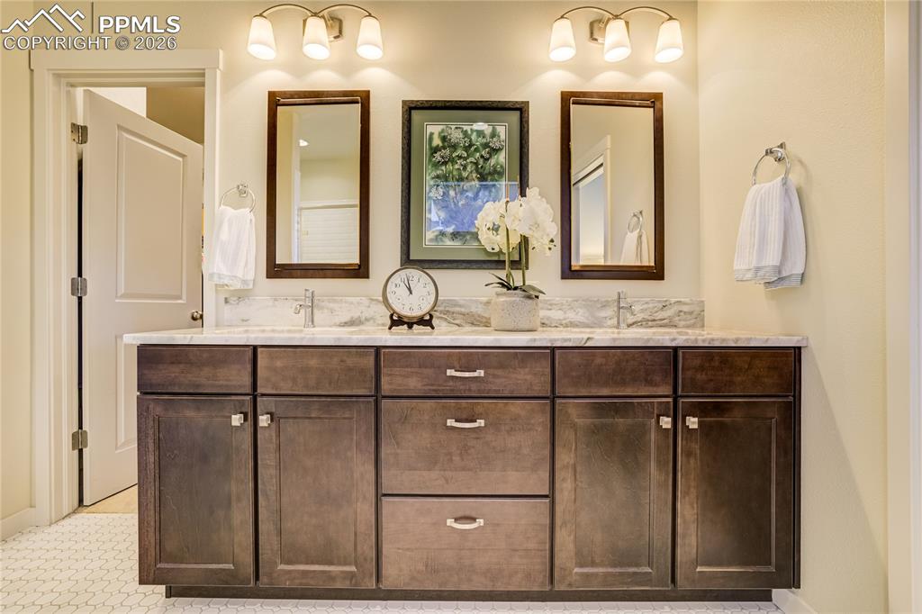 1265 Foothills Farm Way Colorado Springs, CO 80921 - Photo 27 of 50 a bathroom with a sink vanity and mirror