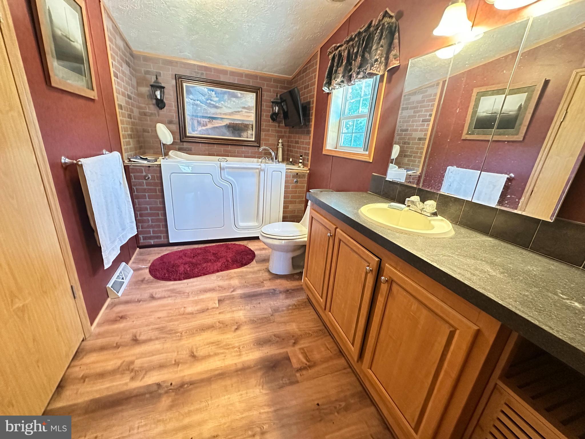 35390 Heron Road Millsboro, DE 19966 - Photo 9 of 25 a bathroom with a tub sink and mirror
