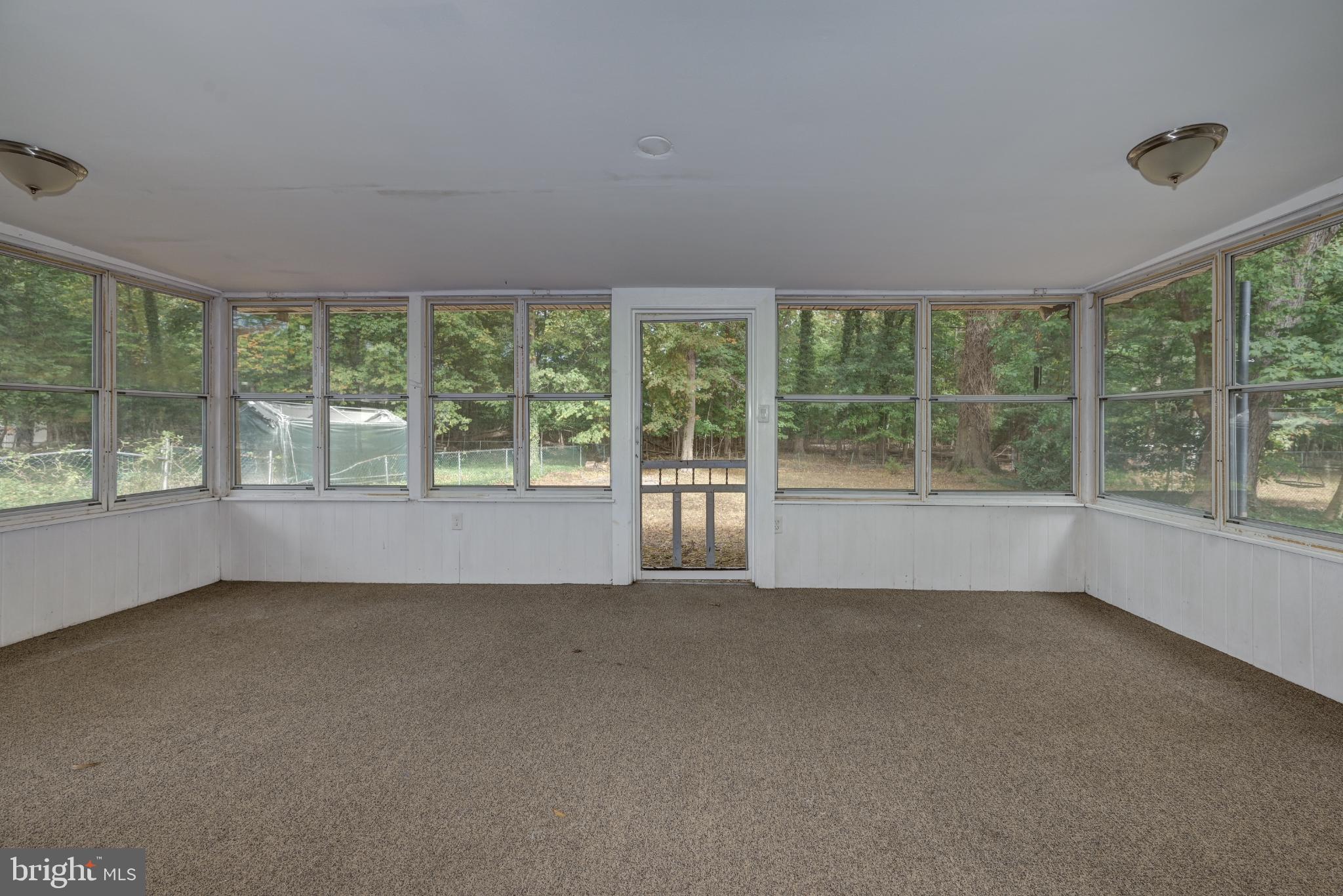 123 Clover Street Mount Holly, NJ 08060 - Photo 28 of 38 Bright sunroom with serene woodland views.