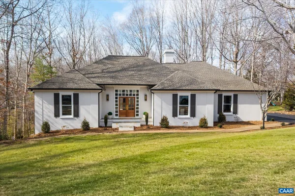 a view of a patio with table and chairs and a large tree