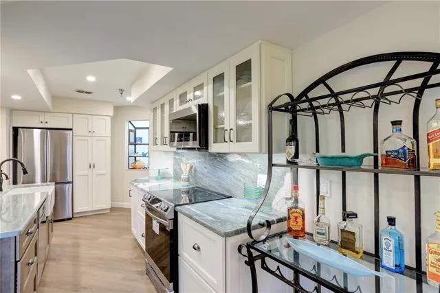 a kitchen that has a lot of cabinets in it