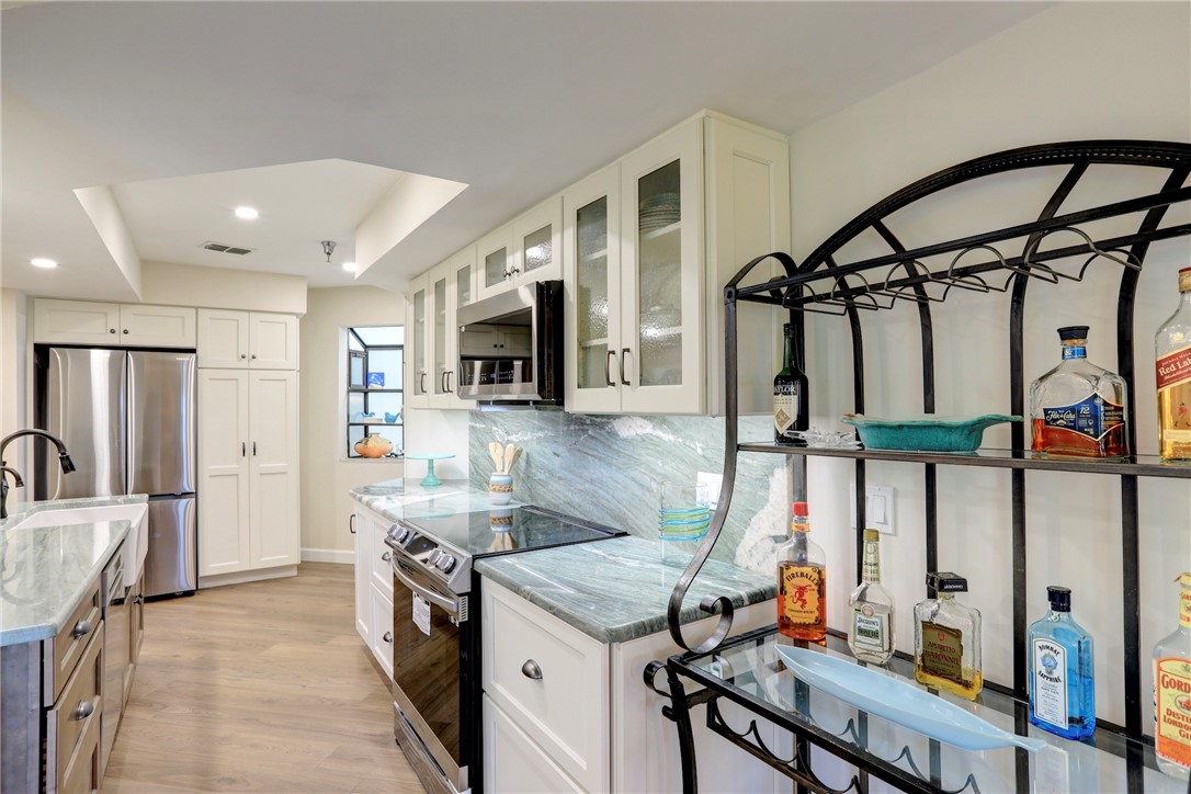 9612 Riverside Drive, Unit 102 Sebastian, FL 32958 - Photo 12 of 32 a kitchen that has a lot of cabinets in it