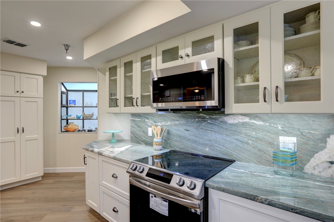 9612 Riverside Drive, Unit 102 Sebastian, FL 32958 - Photo 14 of 32 a kitchen with granite countertop a stove and a sink