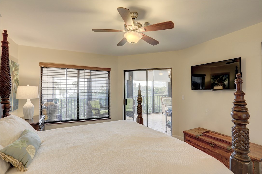 9612 Riverside Drive, Unit 102 Sebastian, FL 32958 - Photo 18 of 32 a bedroom with a bed and a television