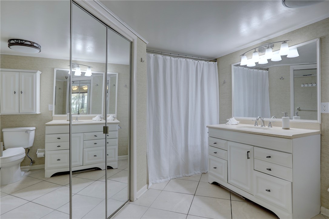 9612 Riverside Drive, Unit 102 Sebastian, FL 32958 - Photo 19 of 32 a bathroom with a double vanity sink mirror and toilet