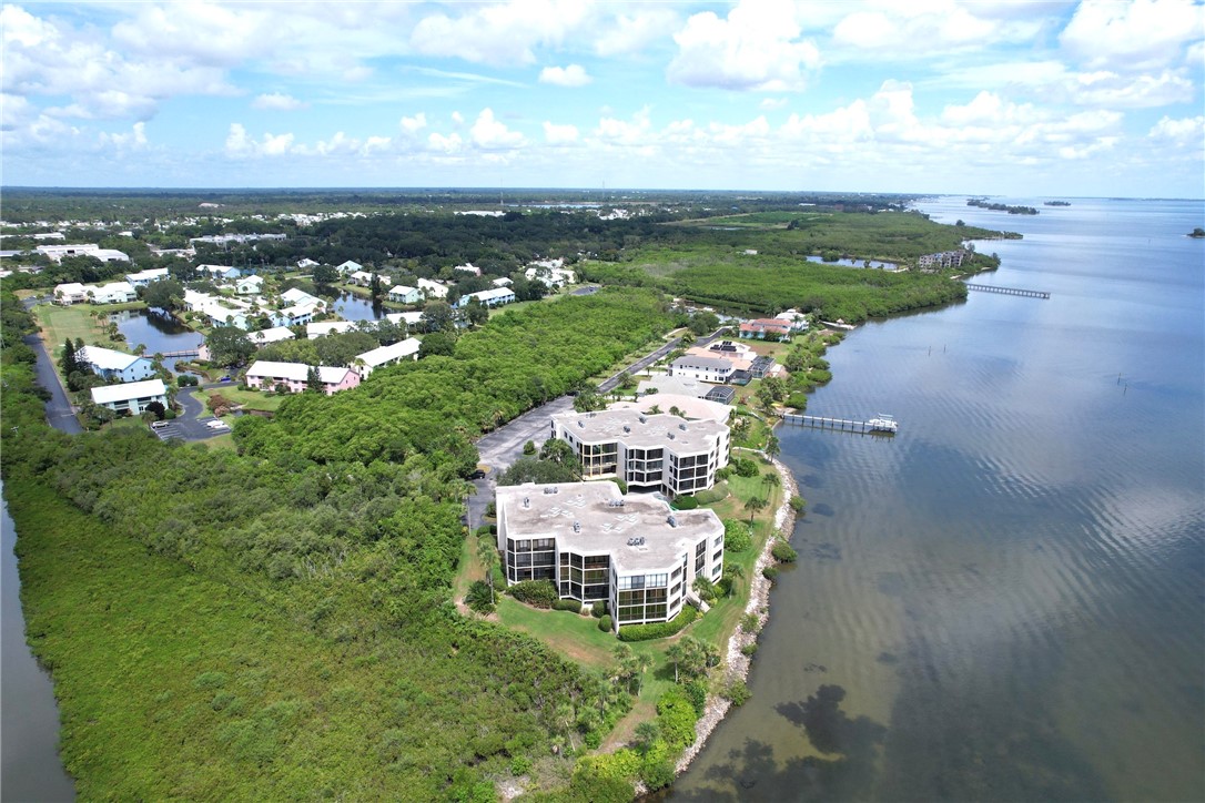 9612 Riverside Drive, Unit 102 Sebastian, FL 32958 - Photo 2 of 32 an aerial view of a house with a yard