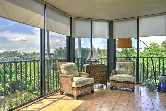 a living room with furniture and a floor to ceiling window