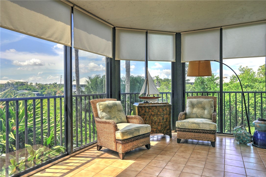 9612 Riverside Drive, Unit 102 Sebastian, FL 32958 - Photo 25 of 32 a living room with furniture and a floor to ceiling window