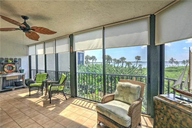 a living room with furniture and a floor to ceiling window