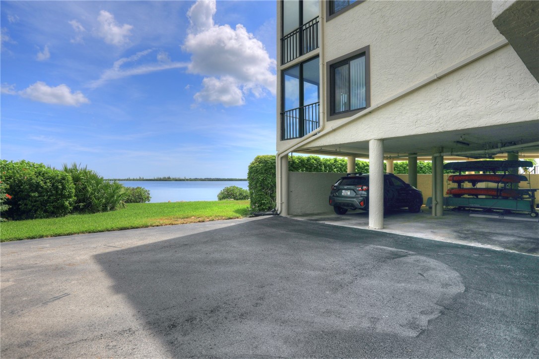 9612 Riverside Drive, Unit 102 Sebastian, FL 32958 - Photo 32 of 32 a view of a house with a yard and a garage