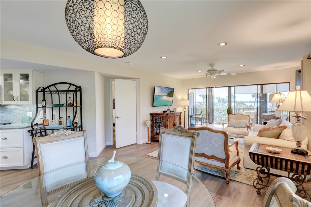 9612 Riverside Drive, Unit 102 Sebastian, FL 32958 - Photo 9 of 32 a living room with furniture a rug and a chandelier