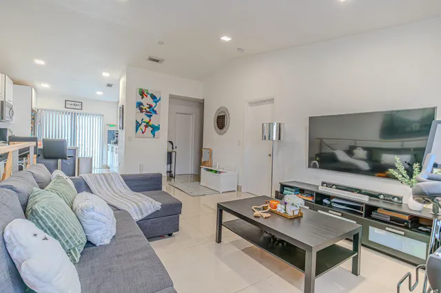 a living room with furniture and flowers