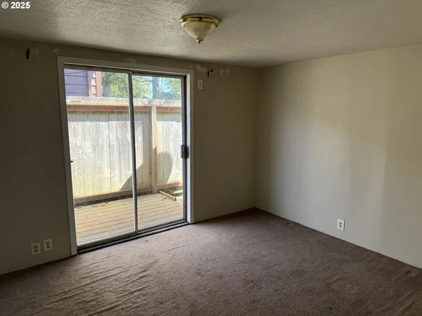 an empty room with wooden floor and door