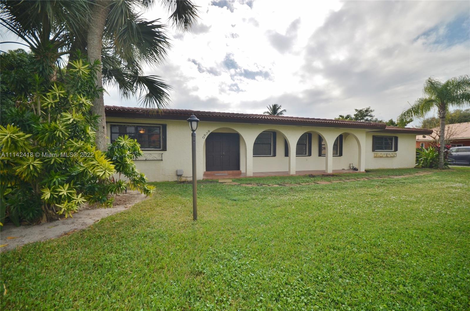 a view of a house with a backyard