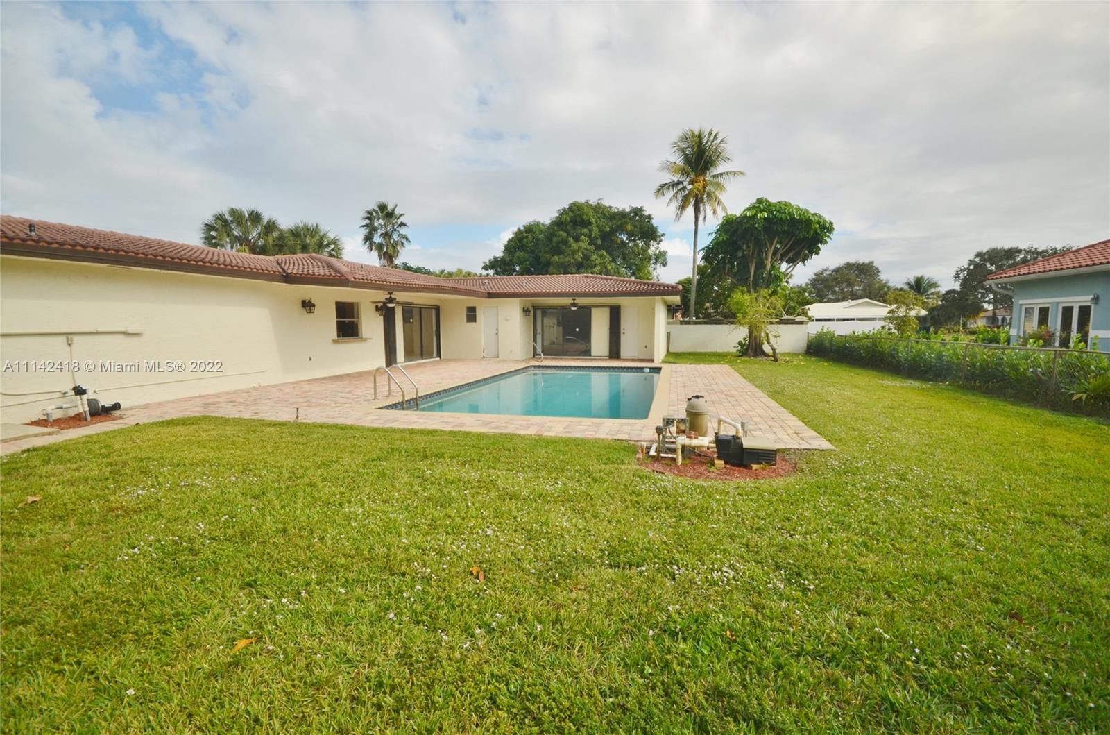 6760 Royal Melbourne Drive Hialeah, FL 33015 - Photo 14 of 36 a view of a house with a yard patio and swimming pool