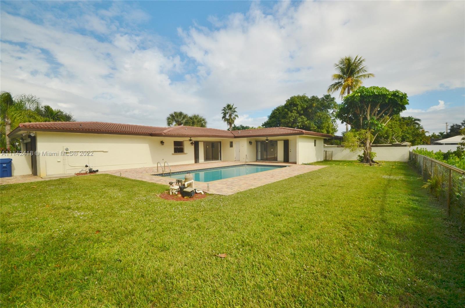 6760 Royal Melbourne Drive Hialeah, FL 33015 - Photo 15 of 36 a view of a house with pool and a yard