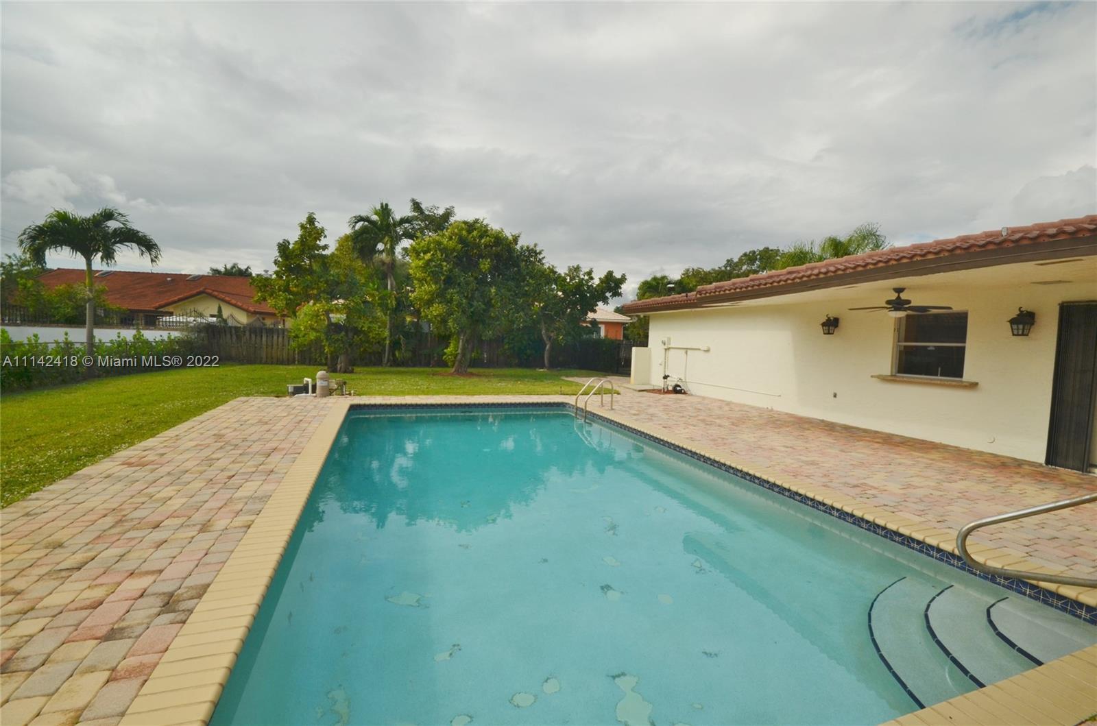 6760 Royal Melbourne Drive Hialeah, FL 33015 - Photo 17 of 36 a view of swimming pool with a yard