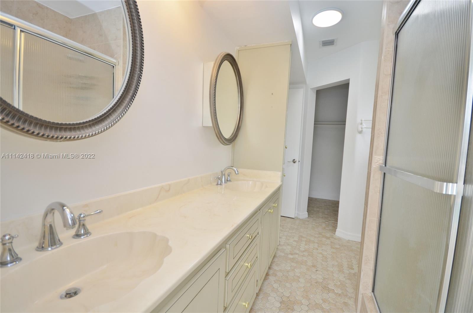 6760 Royal Melbourne Drive Hialeah, FL 33015 - Photo 20 of 36 a bathroom with a sink and a mirror