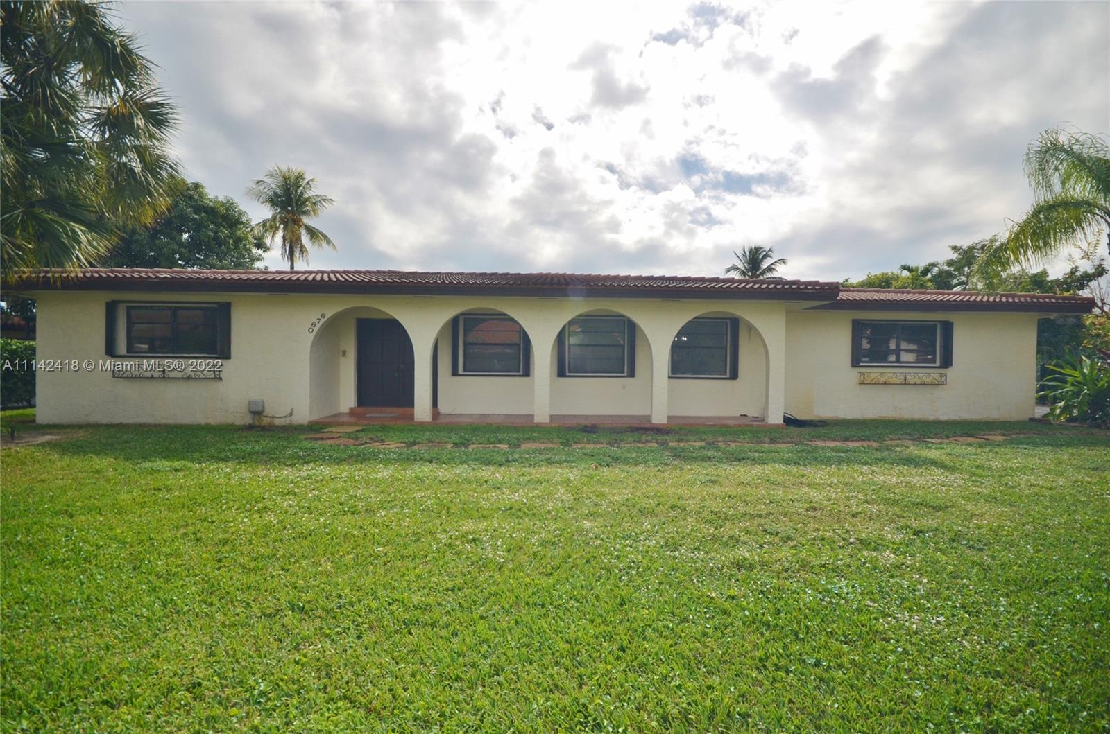 6760 Royal Melbourne Drive Hialeah, FL 33015 - Photo 2 of 36 a view of a backyard with plants and a barn
