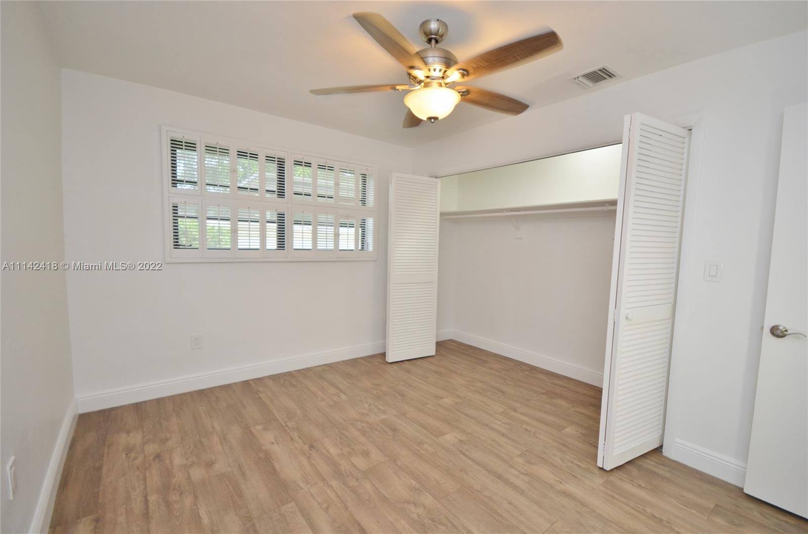 6760 Royal Melbourne Drive Hialeah, FL 33015 - Photo 27 of 36 wooden floor in an empty room with a window