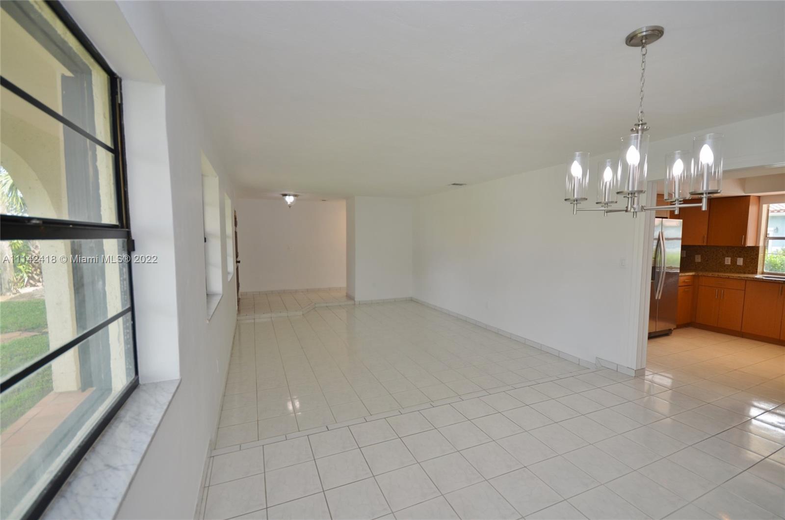6760 Royal Melbourne Drive Hialeah, FL 33015 - Photo 3 of 36 a view of a hallway with a chandelier