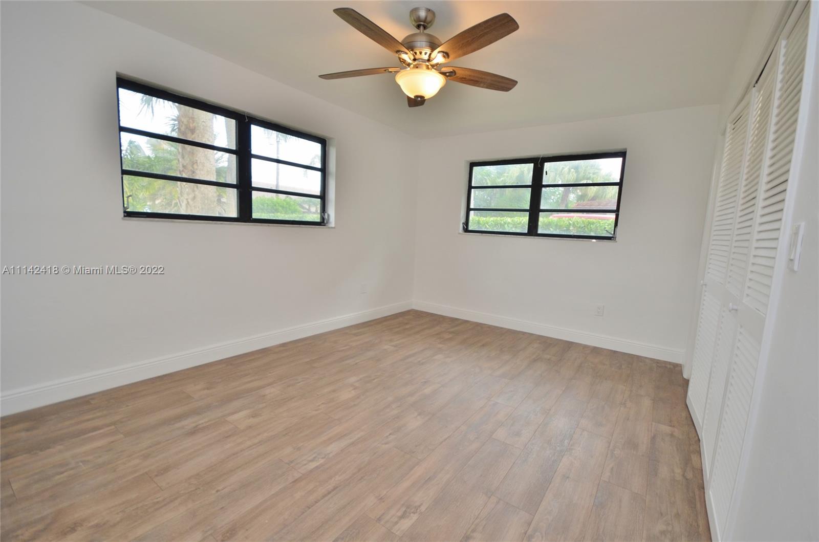 6760 Royal Melbourne Drive Hialeah, FL 33015 - Photo 31 of 36 wooden floor in an empty room with a window